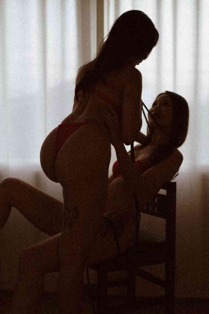 Silhouetted figures of Viola and Cici in intimate embrace