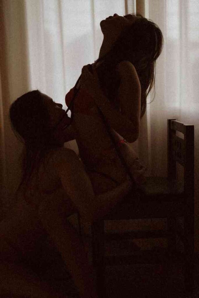 Viola and Cici in an intimate moment, silhouetted against a window.