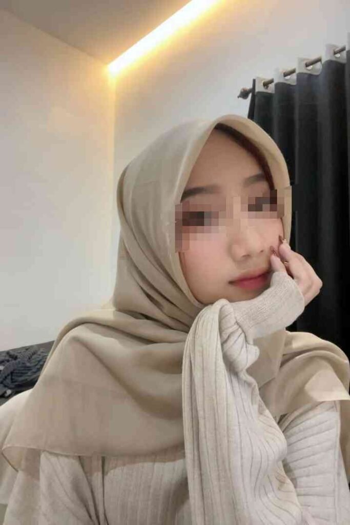 Young Malay woman in hijab, Kesya, posing for discreet session.