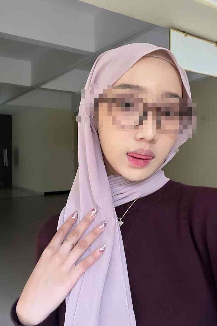 Young woman with pink hijab and sunglasses, KL escort service