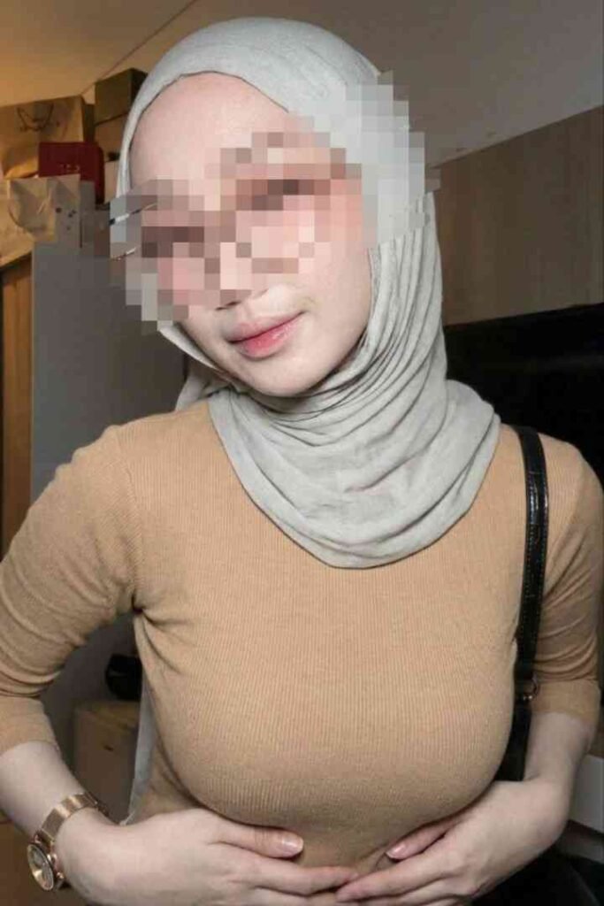 Young woman wearing a hijab and a tan sweater